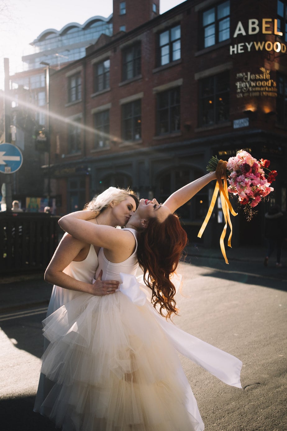 Gorgeous wedding bouquet in reds and pinks, photographed during an Edinburgh wedding at the secret herb garden.