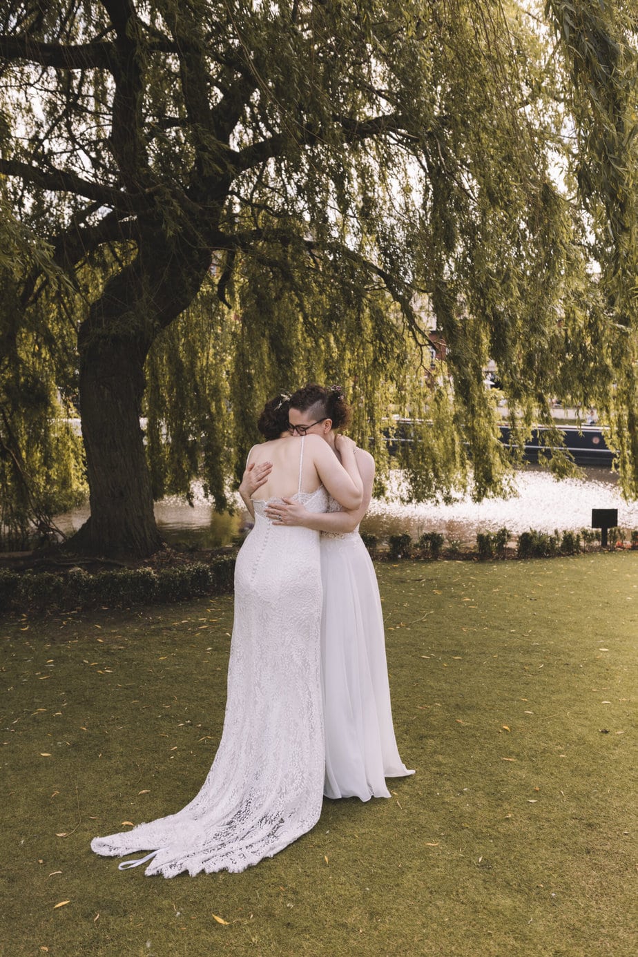 Two brides embracing during the intimate manchester wedding at their small manchester wedding venue